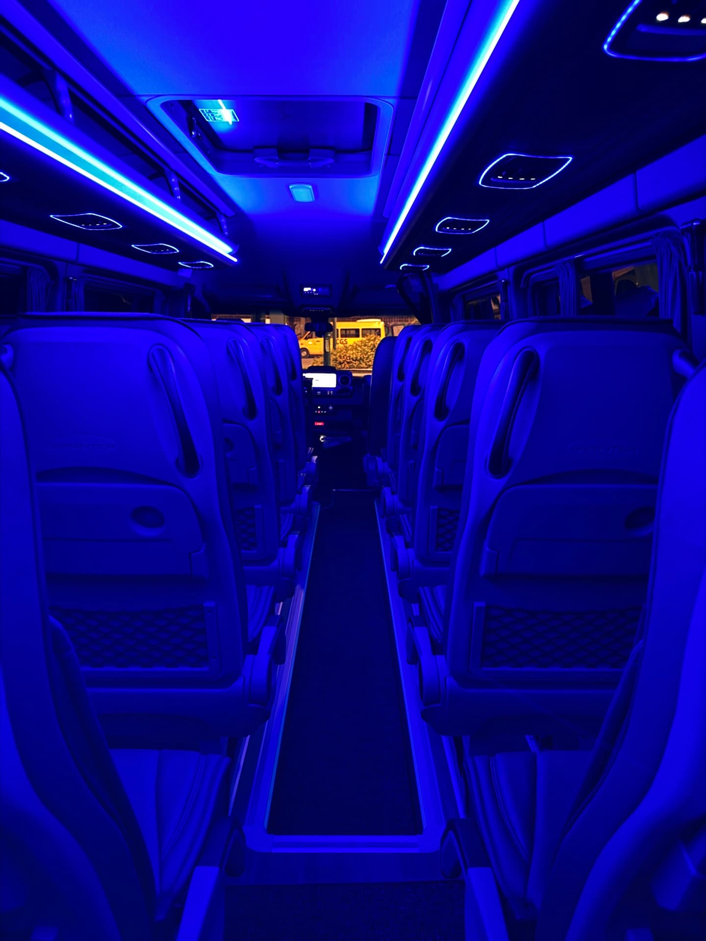The spacious cabin of the Mercedes Sprinter minibus with ambient lighting